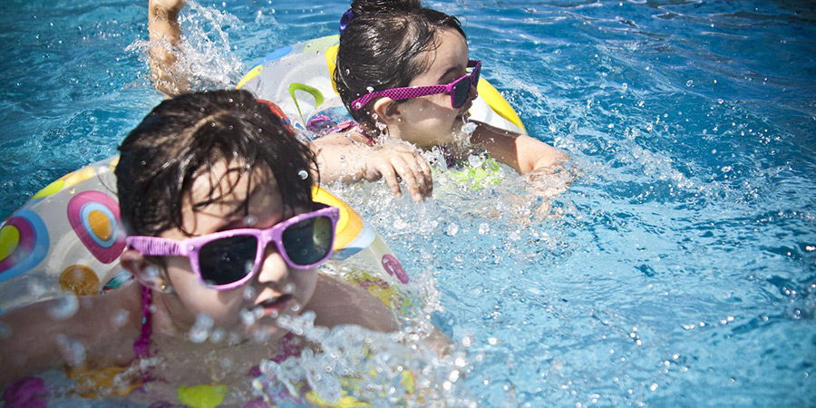 Two young kids in a swimming pool