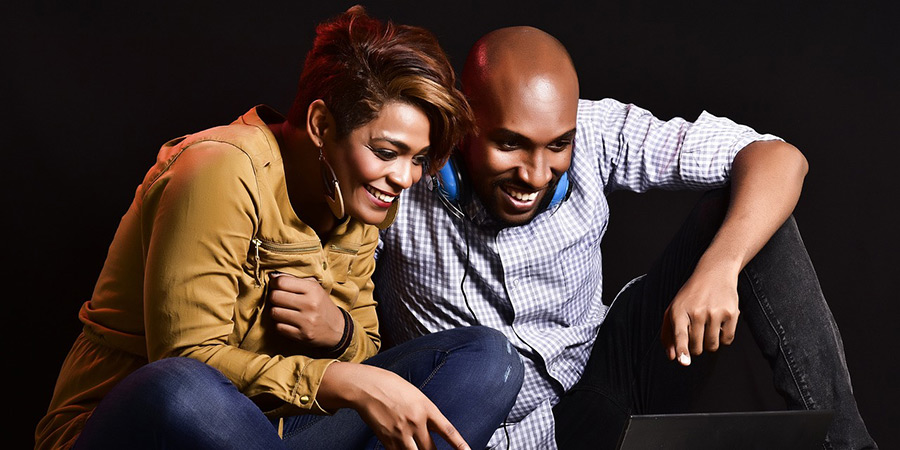 Two people looking at a laptop