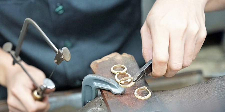 A jeweller working on rings