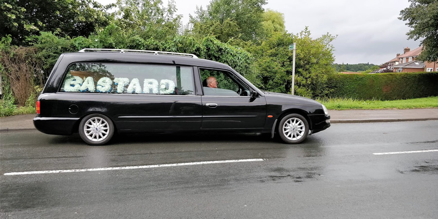 Hearse with the words Bastard. Taken by Final Journey funeral directors