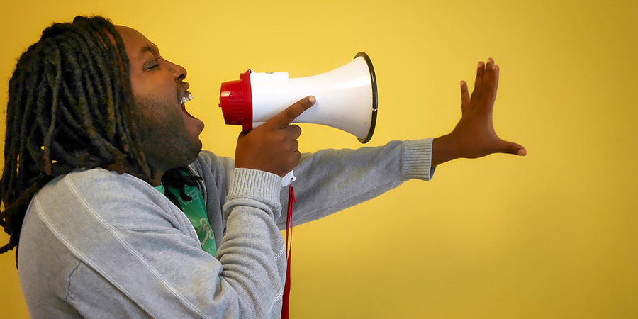 Man shouting in a megaphone Man shouting in a megaphone