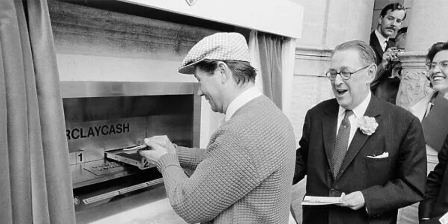 Reg Varney using cash machine