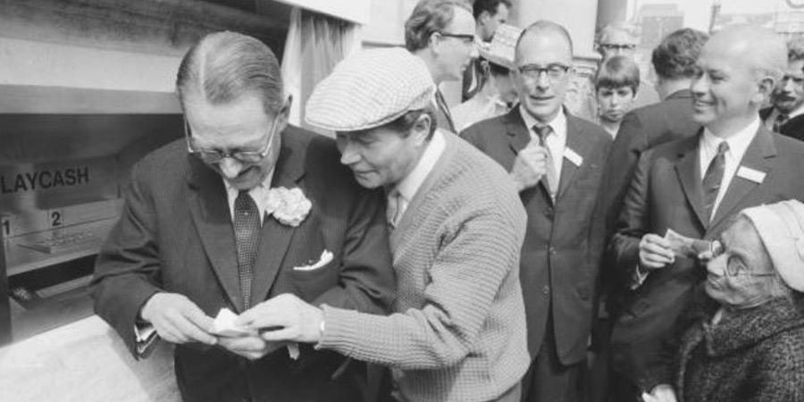 Reg Varney using cash machine