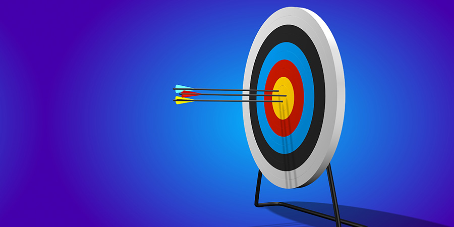 An archery target with three arrows hitting the mark