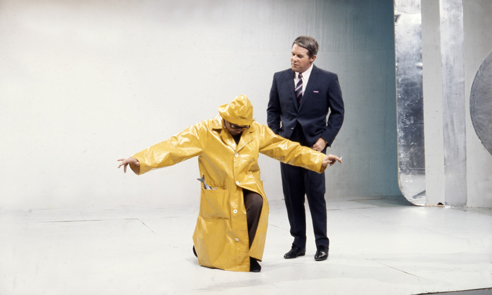 Eric Morecambe in yellow souwester and Ernie Wise on set, 02/09/1968. Image shows from L to R: Eric Morecambe, Ernie Wise. Copyright: BBC History