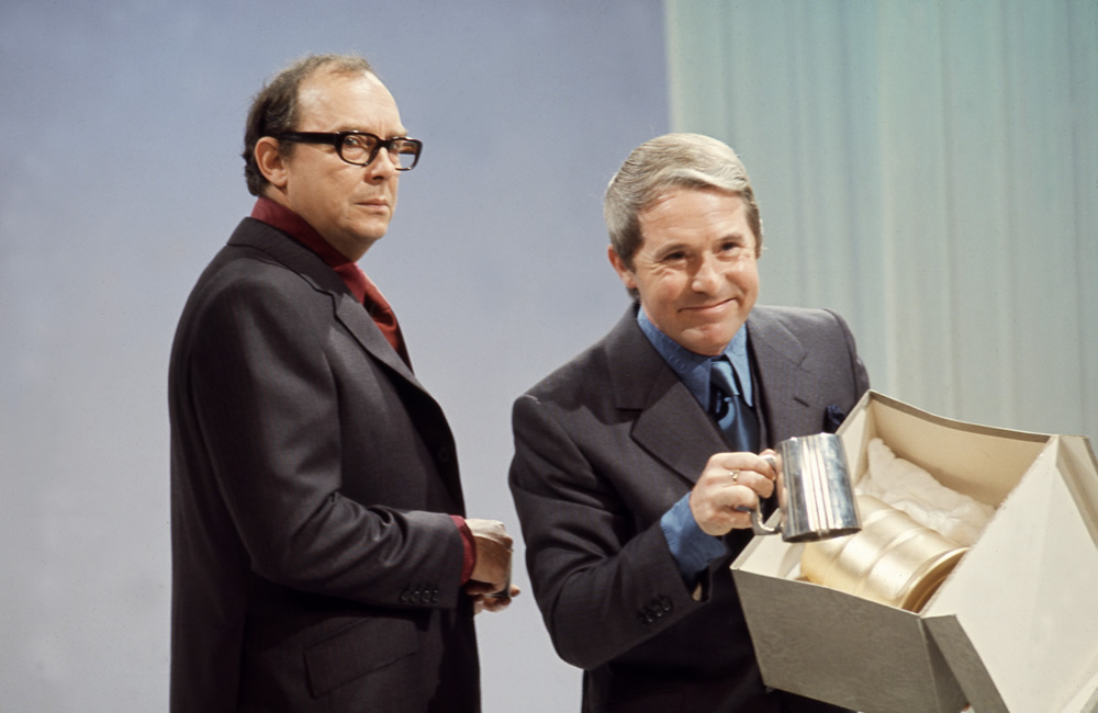 Eric Morecambe and Ernie Wise with tankards and box during Christmas Show, 1971.. Image shows from L to R: Eric Morecambe, Ernie Wise. Copyright: BBC History