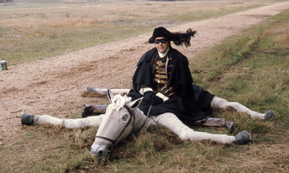 Eric Morecambe as Dick Turpin on collapsed fake horse, 20/10/1975. Eric Morecambe. Copyright: BBC History