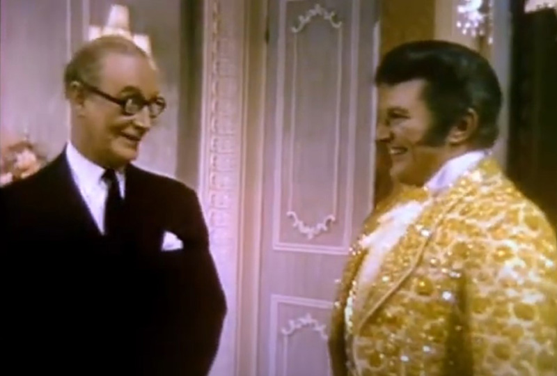 Image shows left to right: Richard Wattis, Liberace. Credit: ITV